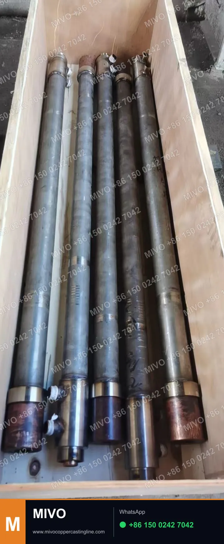Copper rod upcast crystallizer and cooler assemblies for a multi-strand casting line