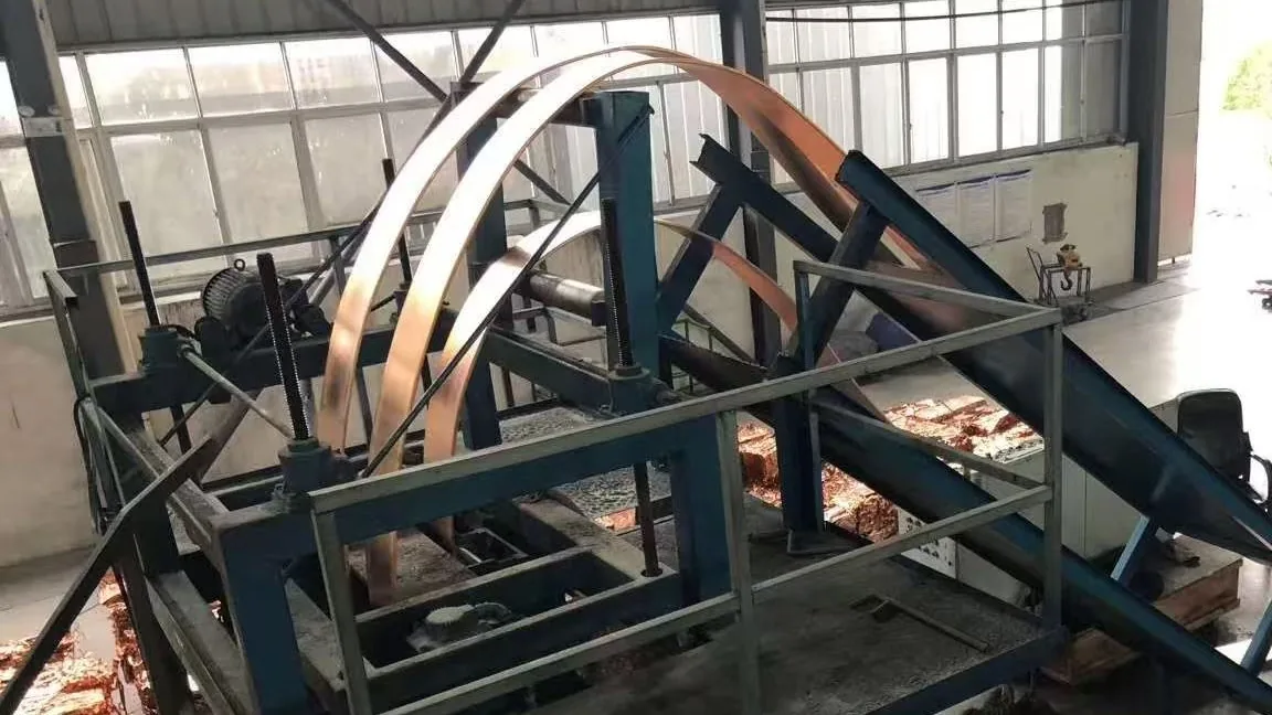 Copper strip handling in an upward continuous casting line